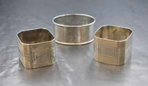 A cased pair of George V silver napkin rings, of square form having engine turned decoration and
