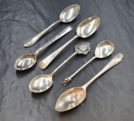 A group of six assorted silver teaspoons, including Old English pattern, a souvenir spoon and one