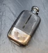 A George V silver mounted glass hip flask, of traditional form having a silver mount and cap to
