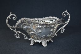 A late Edwardian pierced silver jardiniere, of oval form having a decorative scroll rim and