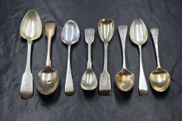 A collection of eight Georgian and Victorian silver teaspoons, of Fiddle and Old English pattern,