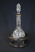 An Elizabeth II silver mounted moulded glass decanter, of bulbous form having grape vine decoration,