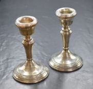 A pair of Elizabeth II silver candlesticks, of traditional form having round sconces with step