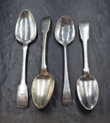 A pair of George III silver fiddle pattern serving spoons, having heraldic crests to terminals,