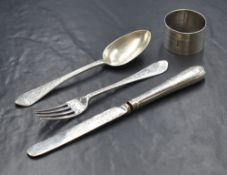 A cased Victorian silver dinner set, comprising fork, knife and spoon with a later addition napkin