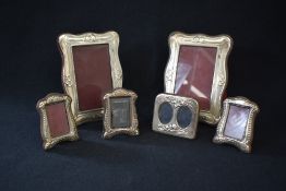 A matched pair of Elizabeth II silver mounted photograph frame, of serpentine rectangular form