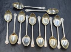 A set of twelve George V silver teaspoons, having bead thread and leaf motif decoration to