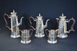 A 20th century white metal five piece tea set, comprising tea, coffee, hot milk, sugar and cream, of