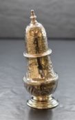 A late George II silver pepperette, of traditional bulbous form having decorative floral and