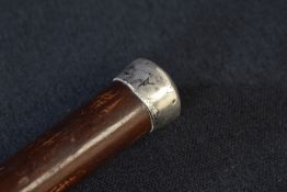 A George V silver mounted walking stick, the pommel being of plain form to the cane, marks for
