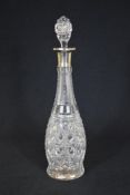 A George V silver mounted cut glass decanter, of slightly bulbous form, marks for Sheffield 1929,