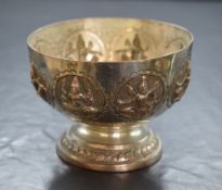 An Eastern white metal pedestal bowl, of circular form having embossed figures in circular panels,