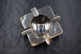 An Elizabeth II silver ash tray, of square form having four cigarette rests with a central