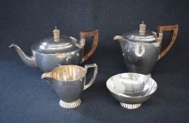 An Elizabeth II silver four piece tea set, comprising tea, coffee, sugar and cream, of circular form