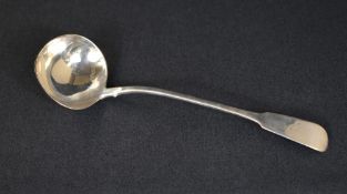 An impressive George III silver fiddle pattern sauce ladle, having a rubbed heraldic crest to