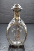 A 20th century silver mounted Haig's whisky bottle, the triangular bottle marked Haig's in a pierced