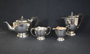 A George VI silver four piece tea set, comprising a teapot, coffee pot, sugar and cream, of circular