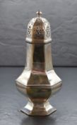 A Victorian silver sugar caster, having a pierced, finial topped cover over the hexagonal body, with