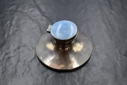 A 20th century silver and enamel inkwell, of traditional circular form with blue quilloche enamel to