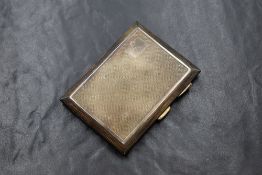 A George V silver cigarette case, of hinged rectangular form having engine turned decoration and