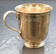 An Elizabeth II silver cup, of traditional form having a slightly flared rim, line work