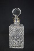 An Elizabeth II silver mounted cut glass decanter, of rectangular form having a silver mount and