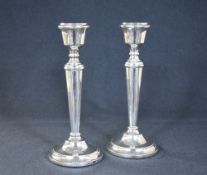 A pair of Elizabeth II silver candlesticks, of traditional form having round step moulded sconces,