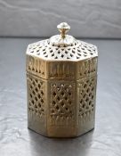 An Eastern white metal Betel nut holder, of octagonal form having a moulded finial top with
