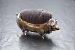An Edwardian silver novelty pin cushion, modelled as a large pig having dark fabric to the body,