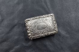 A George VI silver vinaigrette, of hinged rectangular form, having decorative engraving to the front