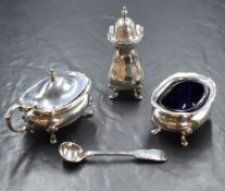 A George V silver condiment set, of bulbous form having Chippendale style rims raised on four