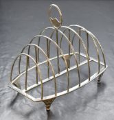 A George III silver toast rack, of rectangular form with rounded divisions, raised on four
