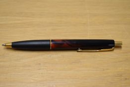 A Parker Frontier ballpoint pen in two tone red and black with gold trim