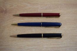 Three Parker 17 propelling pencils in black, red, and blue.