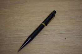 A vintage Montblanc 54 propelling pencil in black with gold trim. In worn condition and has been