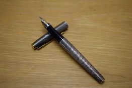 A Parker 75 Cisele converter fill fountain pen in Sterling Silver with gold trim having Parker 14K