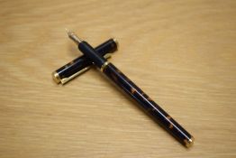 A Dunhill Slimline cartridge fill fountain pen in Thuya laque with gold trim having Dunhill 14K