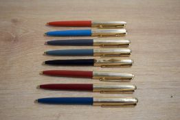 Eight Parker 61 ballpoint pens in Black, Grey, Teal, Red, Burgundy all with fluted gold fill caps (
