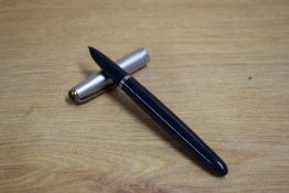 A Parker 51 plunger fill fountain pen in dark blue with twin jewel sterling silver cap. Dents to