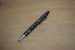 A Montblanc Pix propelling pencil in grey marble with gold trim and chrome point