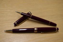 A Montblanc Meisterstuck Solataire Ballpoint pen (IH1514415) and Rollerball (DB154282) in Burgundy