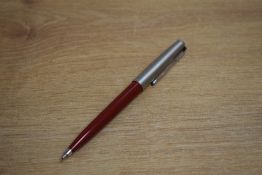 A Parker 61 ballpoint pen in red with lustraloy cap and chrome trim