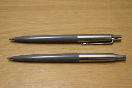 Two Parker Jotter ballpoint pens in grey (one missing clip)