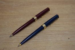 Two Parker 17 Super Duofold ballpoint pens in blue, red with gold trim
