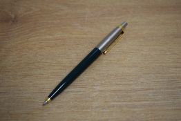 A Parker 45 ballpoint pen dark green with flighter cap having gold trim caps