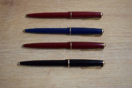 Four Parker 17 Jotter ballpoint pens in black, two red, and blue.