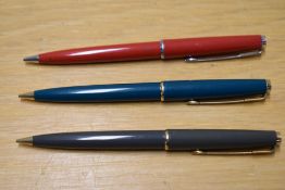 Three Parker 45 propelling pencils in red, green and grey two having gold clips