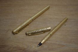 Two Parker 105 rolled gold bark pattern roller ball pens