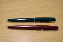 Two Parker 45 ballpoint pens one in green the other burgundy