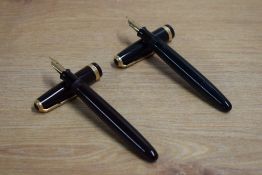Two Parker Duofold button fill fountain pens one in dark brown the other black with Duofold broad